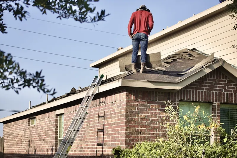 Professional roofer working on a residential roof in Scoggins Ridge